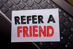 A card that says refer a friend on it.